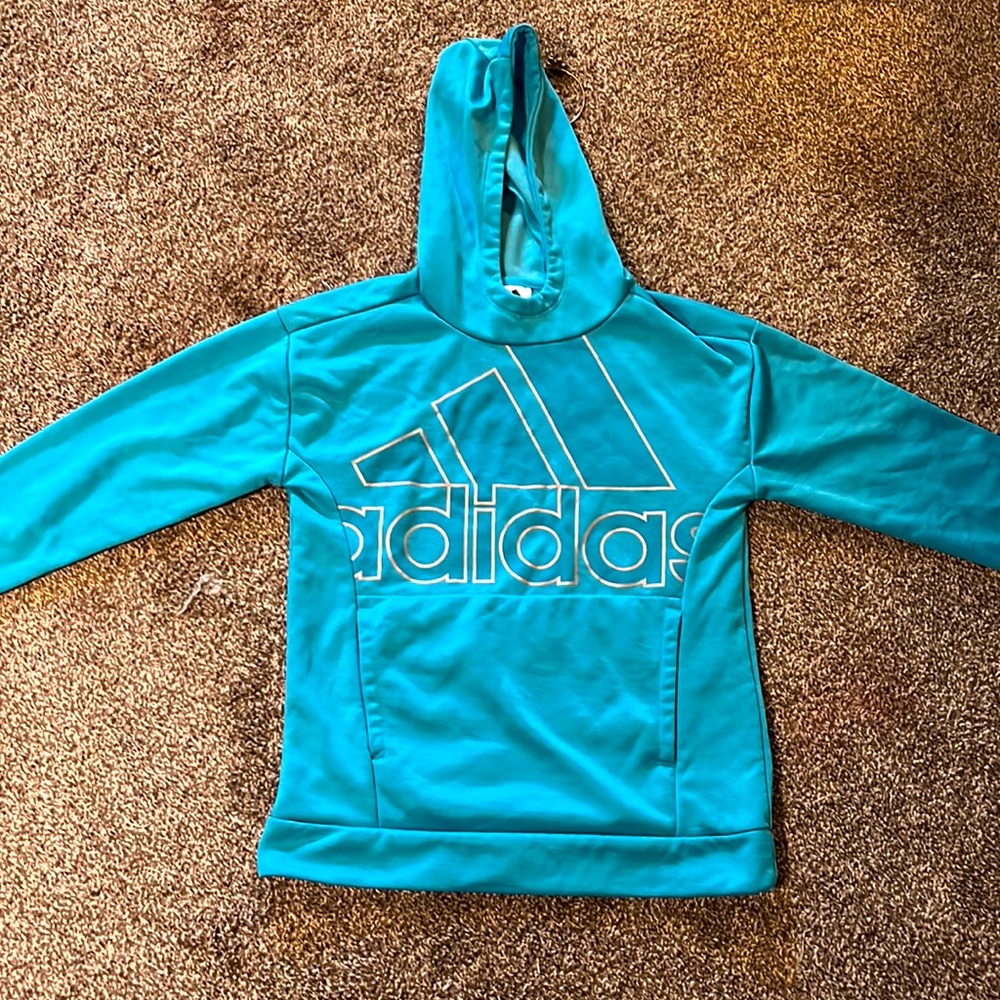 This is an adidas sweat shirt. Very pretty like blue ish teal color.